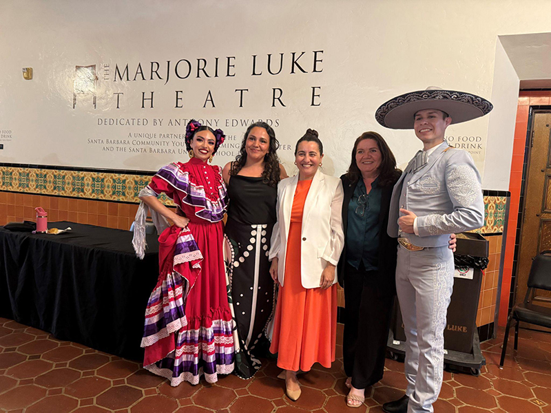Pro Tempore Monique Limón with members of Viva El Arte outside of a theater with folklórico dancers
