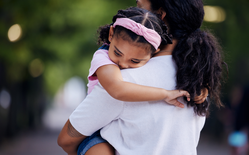 child being held by woman 