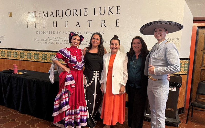 Pro Tempore Monique Limón with members of Viva El Arte outside of a theater with folklórico dancers