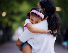mother holding child in bear hug 