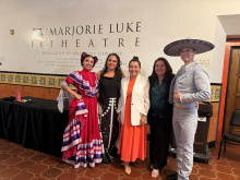 Pro Tempore Monique Limón with members of Viva El Arte outside of a theater with folklórico dancers